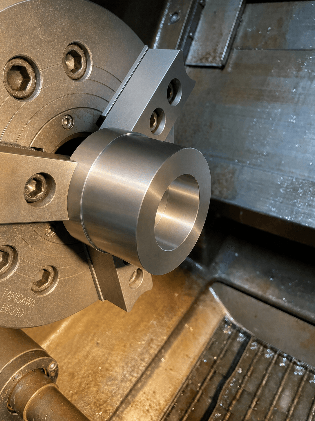 CNC lathe turning a precision steel component